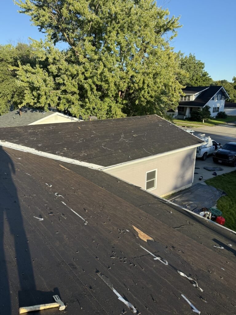 Roof tear-off viewed from the rooftop with old felt removed by Hutch Unlimited Roofing