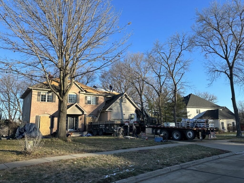 Shingle delivery by crane truck during a roof replacement by Hutch Unlimited Roofing, Iowa