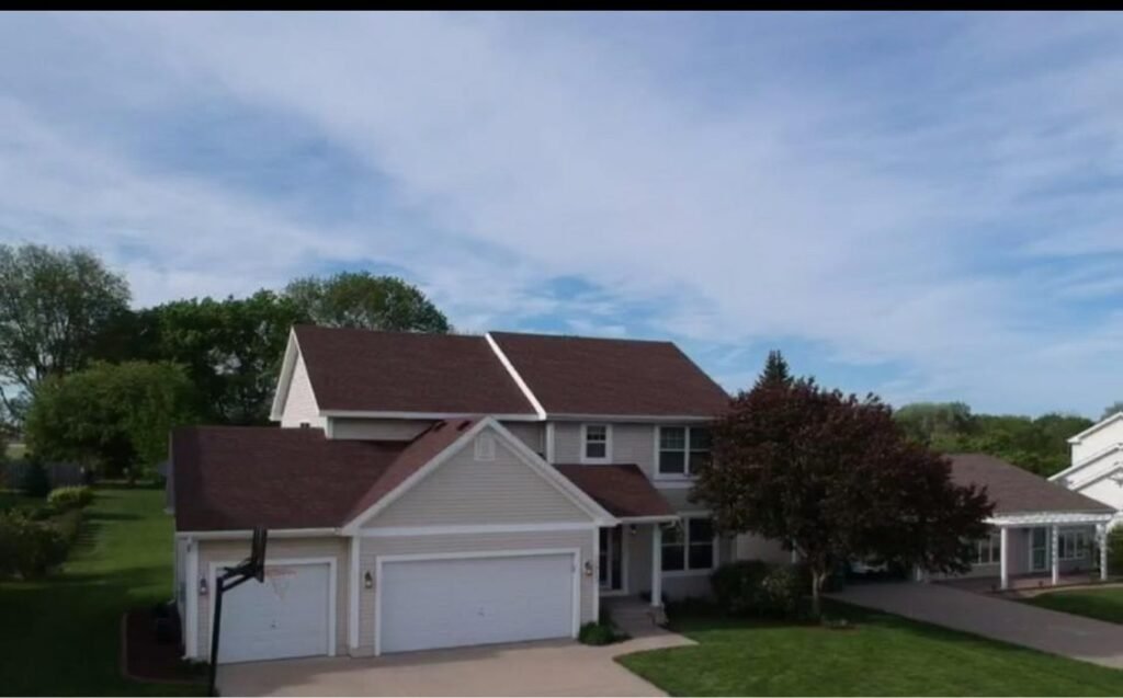 New brown shingle roof on a two-story home by Hutch Unlimited Roofing, Iowa