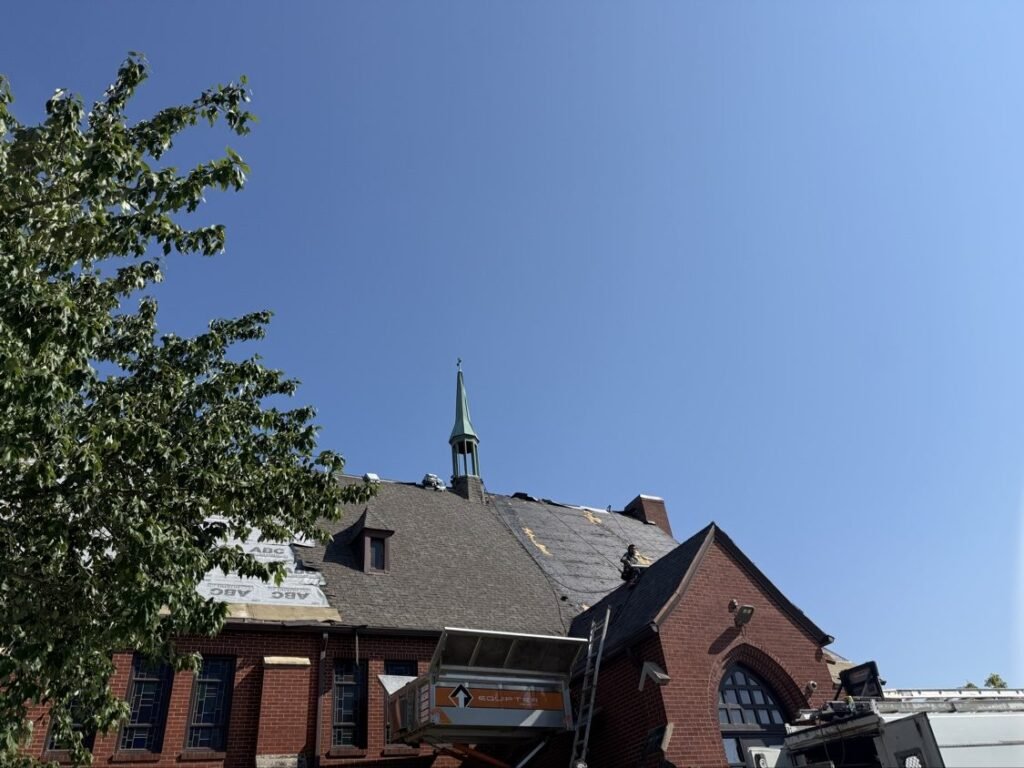 New shingles going on a brick church roof by Hutch Unlimited Roofing, Iowa
