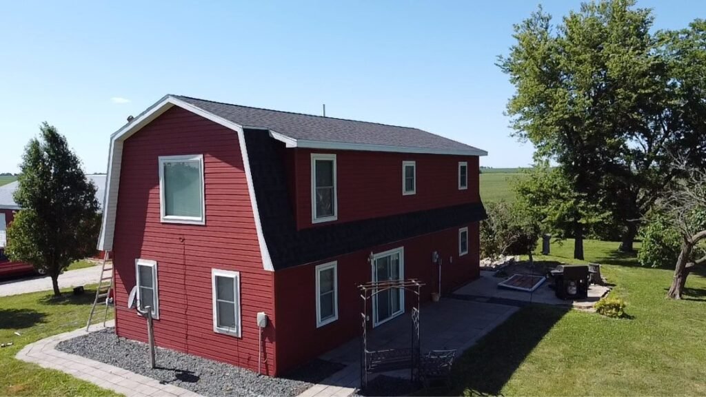 Aerial side view of completed gambrel roof replacement by Hutch Unlimited Roofing, Iowa