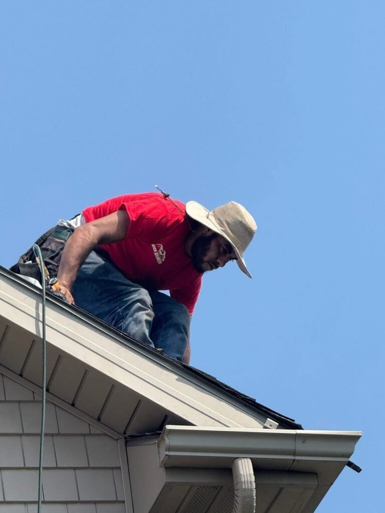 Hutch Unlimited Roofing crew member working on a roof edge, Iowa
