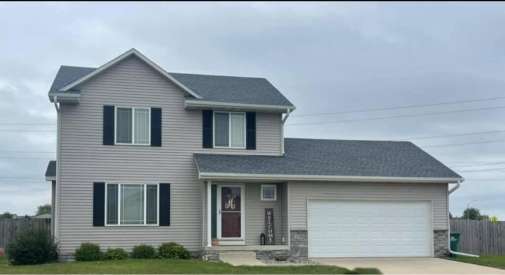 New gray shingle roof on a two-story home by Hutch Unlimited Roofing, Iowa
