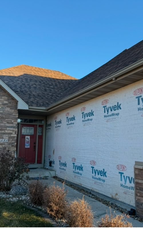 worker doing roofing job on house